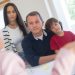 A family of four seeks advice from a professional during an indoor consultation in a bright room.
